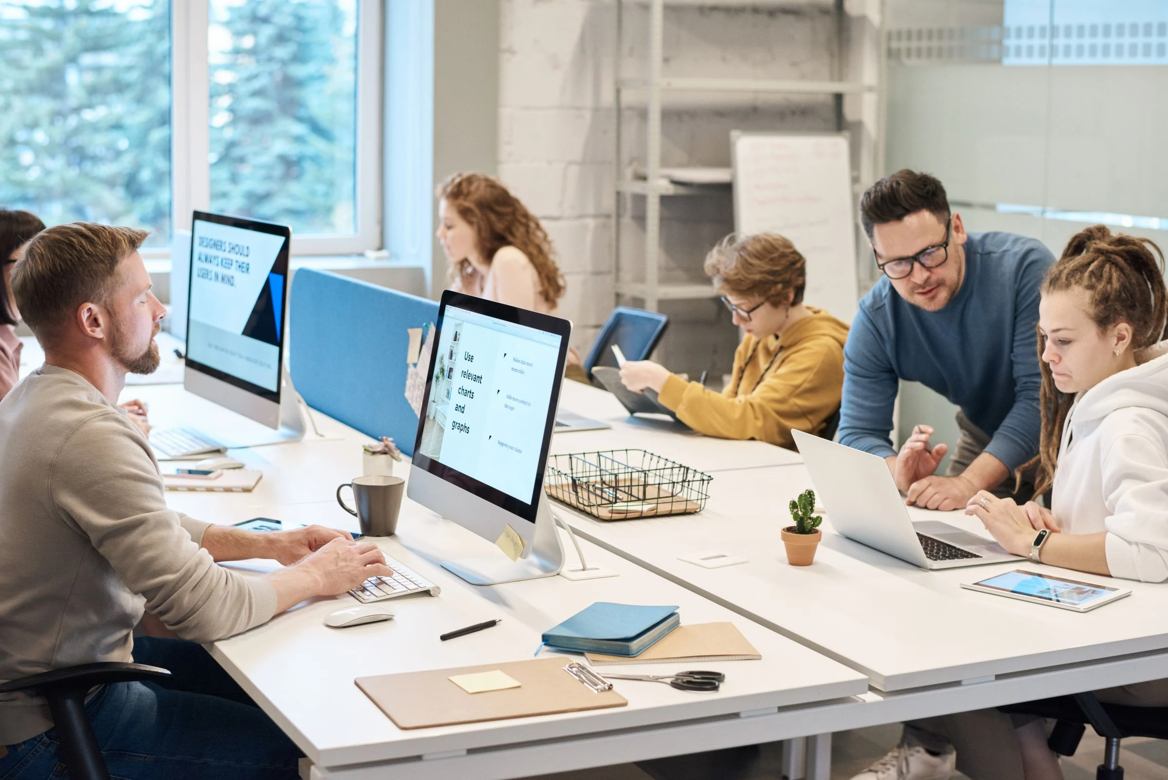 Colleagues working together in a bright shared office